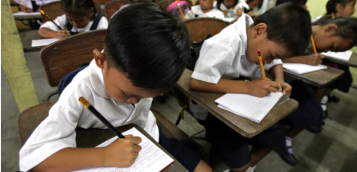 A student writing in a notebook